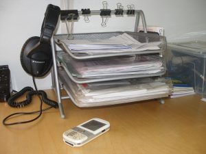 A desk with documents and a laptop